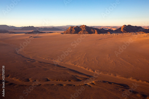 Colorful hot-air balloon flying over the high mountains in Namibia. High altitude. ( Namibia, South Africa)