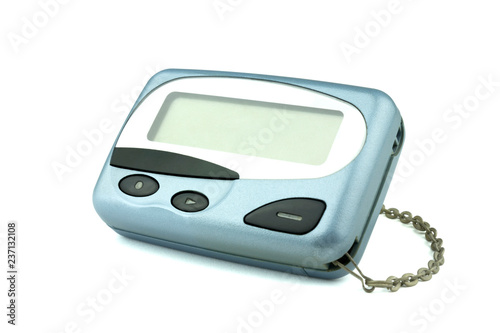 Close-up front old a cyan metallic pager or beeper on white floor, isolated with clipping path on white background. photo