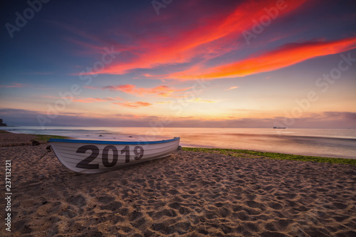 Boat on the beach and sea sunrise, New year 2019 concept.