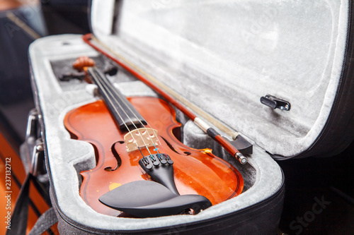 brown vintage violin lying in a case