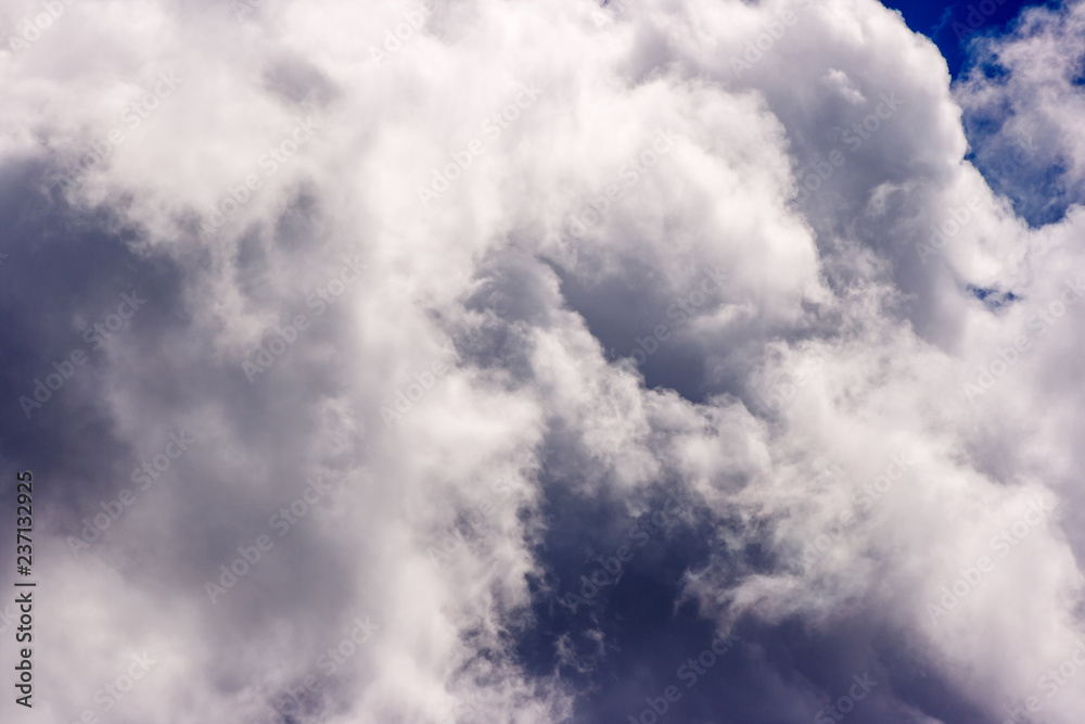 dense and great white clouds on a beautiful summer blue sky