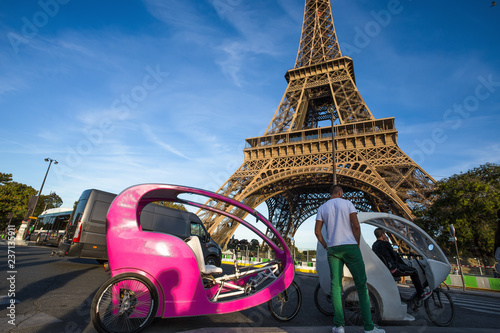 PARIS, FRANCE, SEPTEMBER 8, 2018 - Rickshaws for tourists near Eiffel Tower in Paris, France