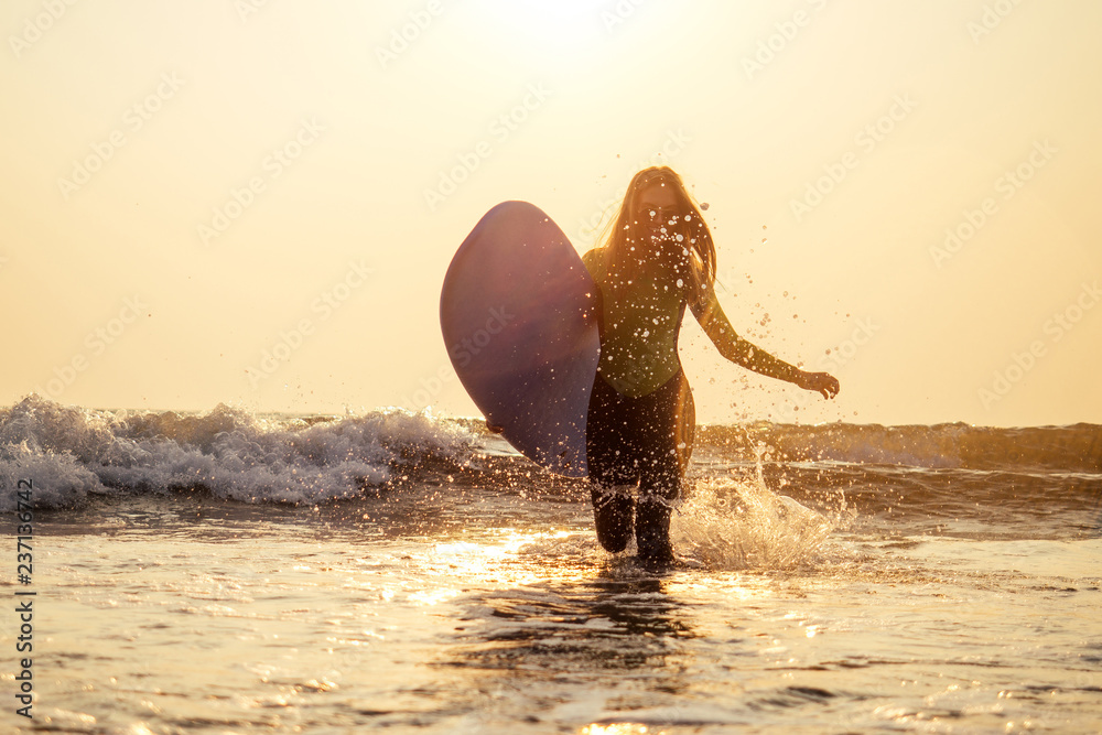 active women with surf board enjoy watersport at vacation holidays