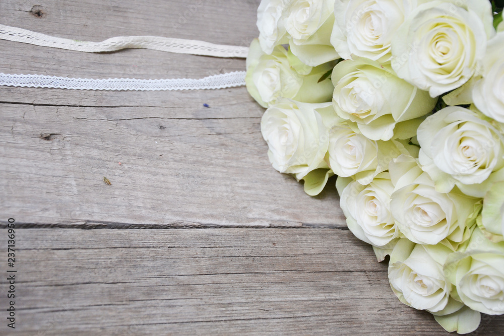 White roses on wooden background White roses on wooden background
