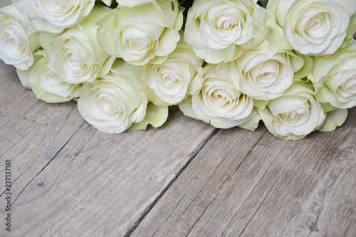 White roses on wooden background
