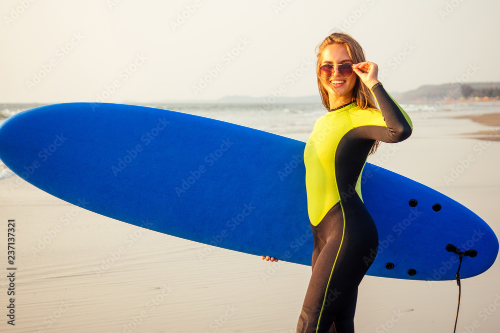 Young sexy woman wetsuit sportive body diving suit with surf board on