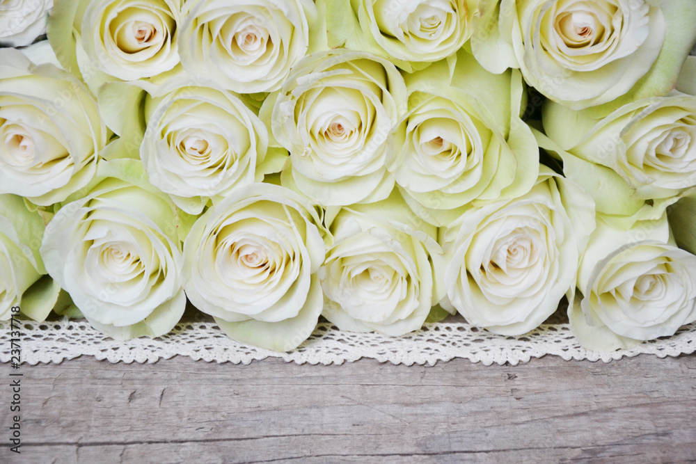 White roses on wooden background White roses on wooden background