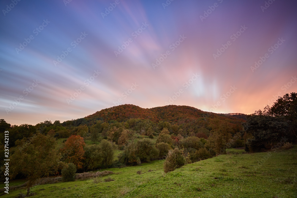 Nice long exposure picture, cloudscape over the mountain in sunset and autumn colors