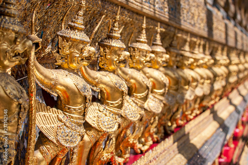 Garudas and nagas on external decorations of the Ubosoth, Wat Phra Kaew temple, Grand Palace, Bangkok, Thailand. photo