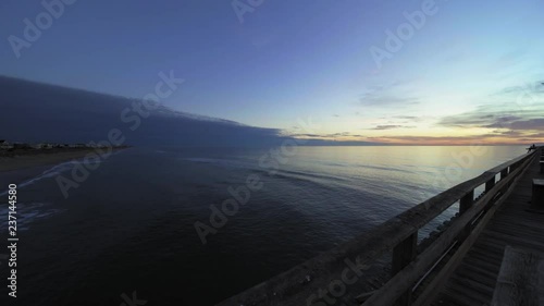 view of the ocean looking over the railing of the fishing pier 
