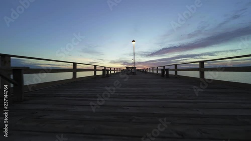 low shot moving forward on the fishing pier at dawn
