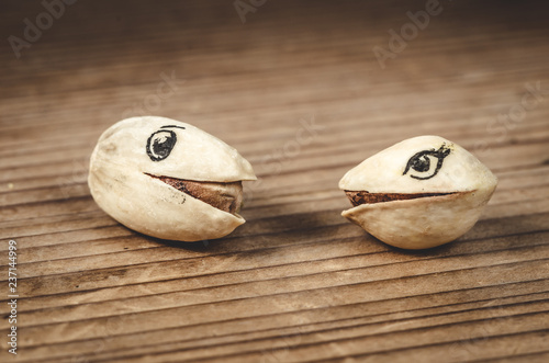 Pistachio nuts with funny drawn on eyes - Realtionship concept photo