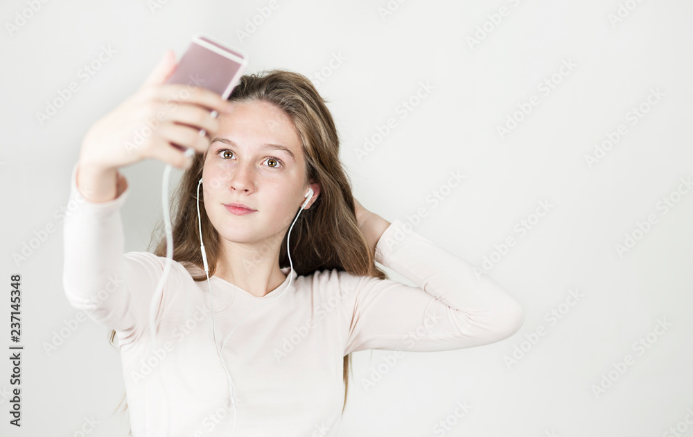 beautiful girl in headphones with a phone in her hands listens to music beautiful girl in headphones with a phone in her hands listens to music