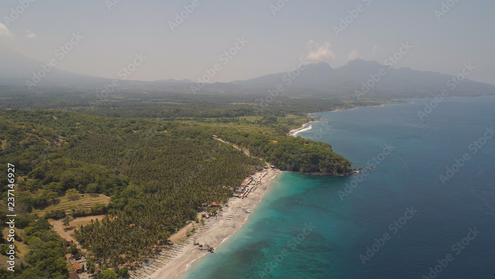 sandy beach with palm trees in tropical resort. aerial seascape sand beach with turquoise water. Seascape, ocean and beautiful beach.Travel concept. Indonesia, Bali