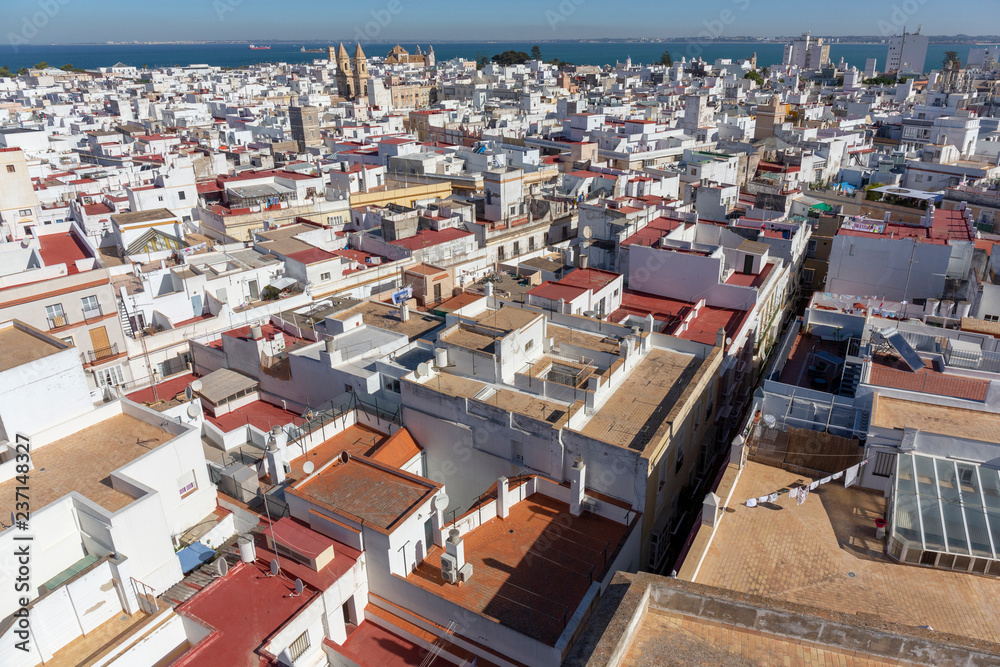 Fototapeta premium Aerial panoramic view of the old city rooftops and Cathedral de Santa Cruz in the morning from tower Tavira in Cadiz, Andalusia, Spain