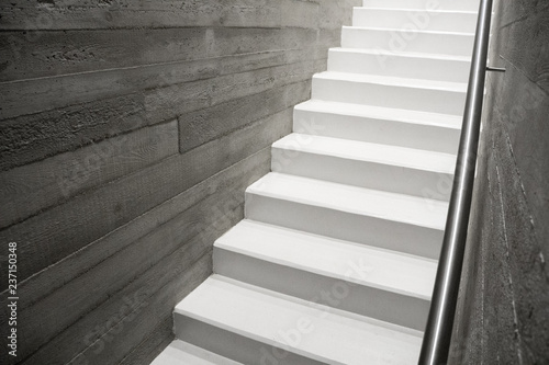 Modern reinforced concrete staircase with stainless handrail in interior of contemporary house, New stairs made of raw concrete
