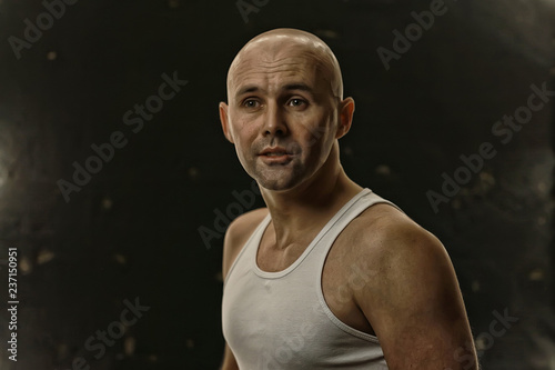 athlete in a shirt photo in studio / isolate on a black background, athlete in a white t-shirt © kichigin19
