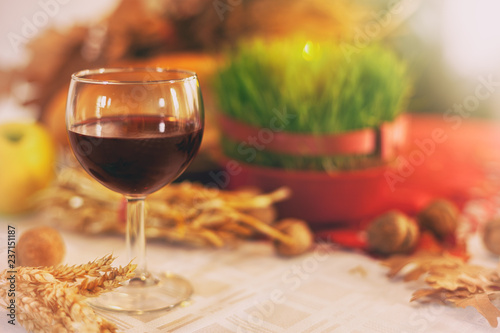 Wine glass with Christmas wheat and offerings, background photo