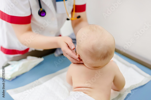 Little cute baby boy visiting doctor . Pediatrician make check up and examining infant for disease prevention protocol. Children healthcare concept