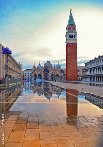 VENICE  ITALY. Sunrise with empty St Mark s Square with flood and beautiful water reflections of Bells tower and St. Marks Cathedral Basilica on wet floor.