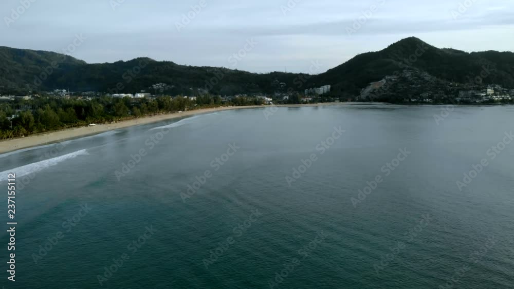 Aerial drone shot - Thai beach on the daylight with wavy blue water Aerial drone shot - Thai beach on the daylight with wavy blue water