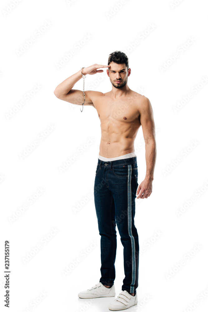 handsome man with handcuffs on hand looking at camera and saluting isolated on white handsome man with handcuffs on hand looking at camera and saluting isolated on white