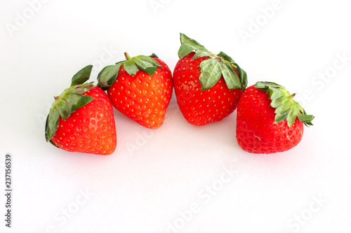 Fresh strawberry fruit isolated on white paper background.