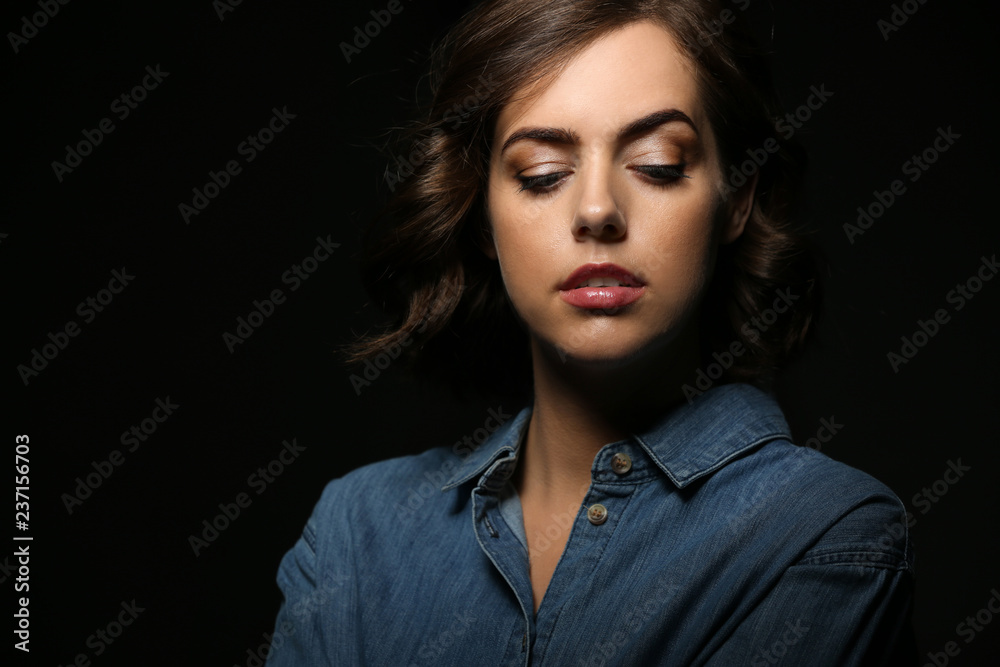 Portrait of beautiful young woman on dark background Portrait of beautiful young woman on dark background