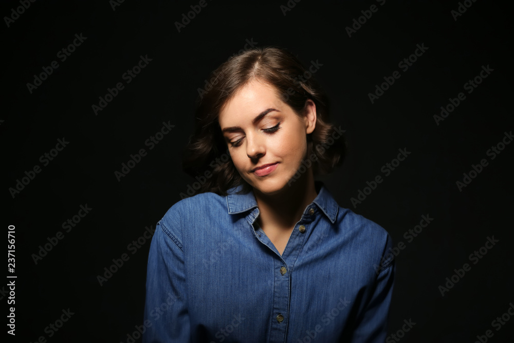 Portrait of beautiful young woman on dark background Portrait of beautiful young woman on dark background