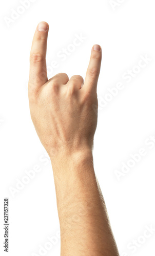 Male hand showing "devil horns" gesture on white background