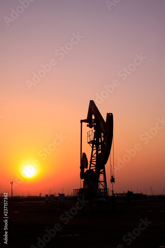 Crank balanced beam pumping unit in Jidong oilfield sunset scenery, closeup of photo photo