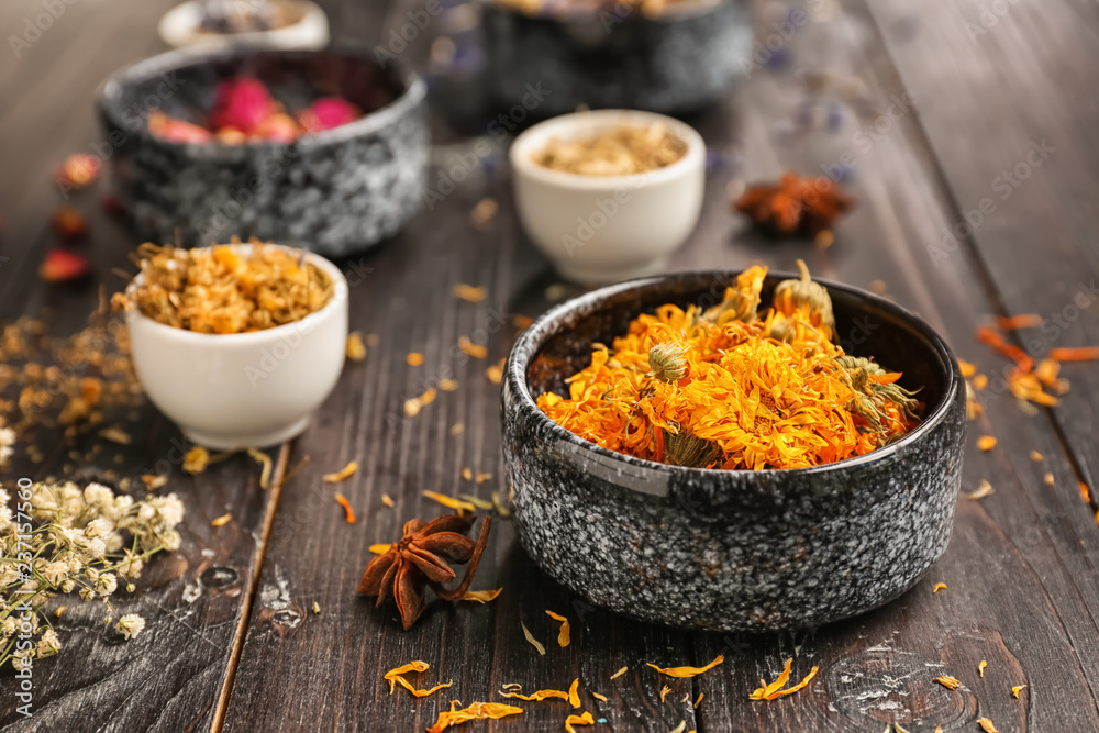 Bowls with dried flowers on dark wooden table Bowls with dried flowers on dark wooden table