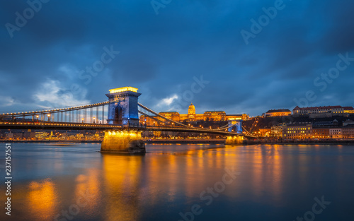 Budapest, Hungary - Beautiful Szechenyi Chain Bridge in unique blue colour with Buda Castle Royal Palace at background at dusk