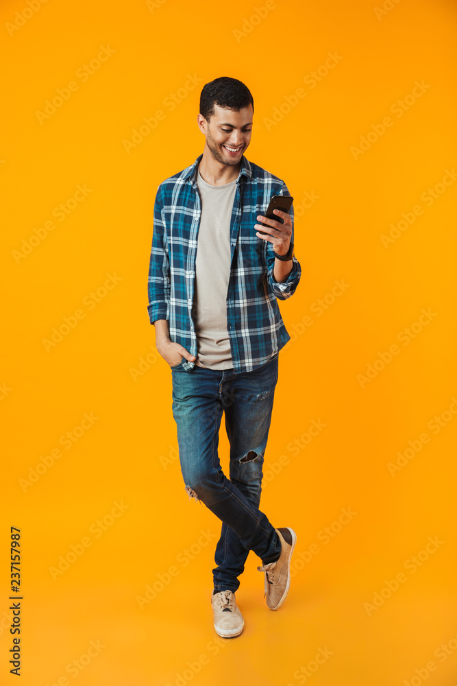 Fototapeta premium Full length portrait of a happy young man