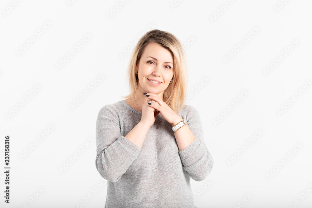 Portrait of attractive and smiling middle aged woman on grey background Portrait of attractive and smiling middle aged woman on grey background