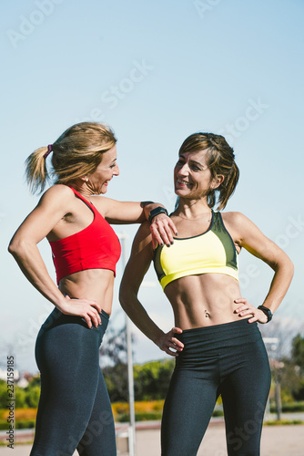 Two happy women training in the park