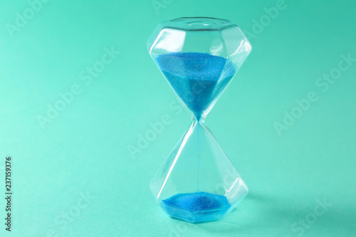 Hourglass on color background. Time management concept