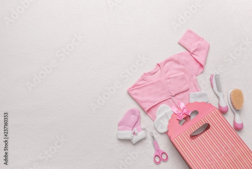 Set of clothes for the newborn and child care items.