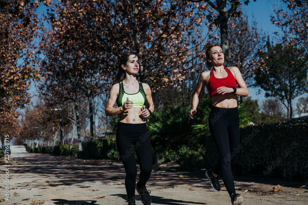 Two happy women training in the park Two happy women training in the park