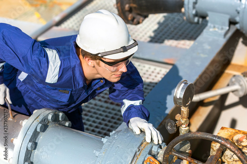Safety officer check a pressure in a cargo line of a tanker.