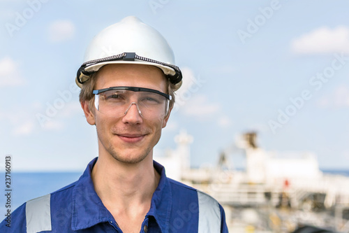 Portrait of a young european engineer in a helmet and safety goggles.