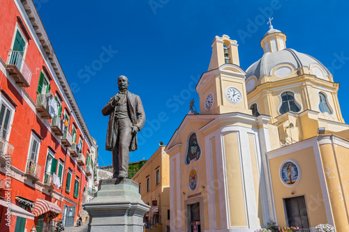 Antonio Scialoja statue on Terra Murata quarter and Santa Maria delle Grazie church, Marina di Corricella, Procida, Gulf of Naples, Campania, Italy. photo