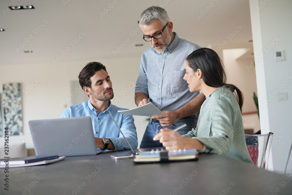 Young colleagues with older boss working with computers Young colleagues with older boss working with computers