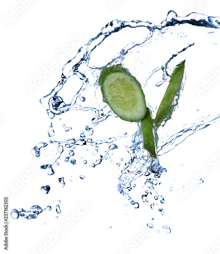 Sliced cucumber with water splash or explosion flying in the air isolated on black background
