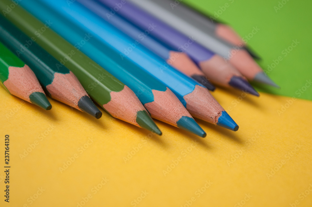 Fototapeta premium closeup of colouring pencils on color background