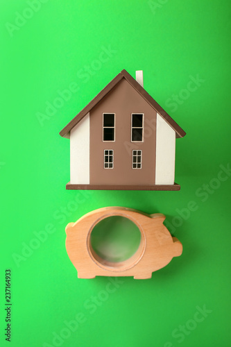 Wooden piggy bank with hous...