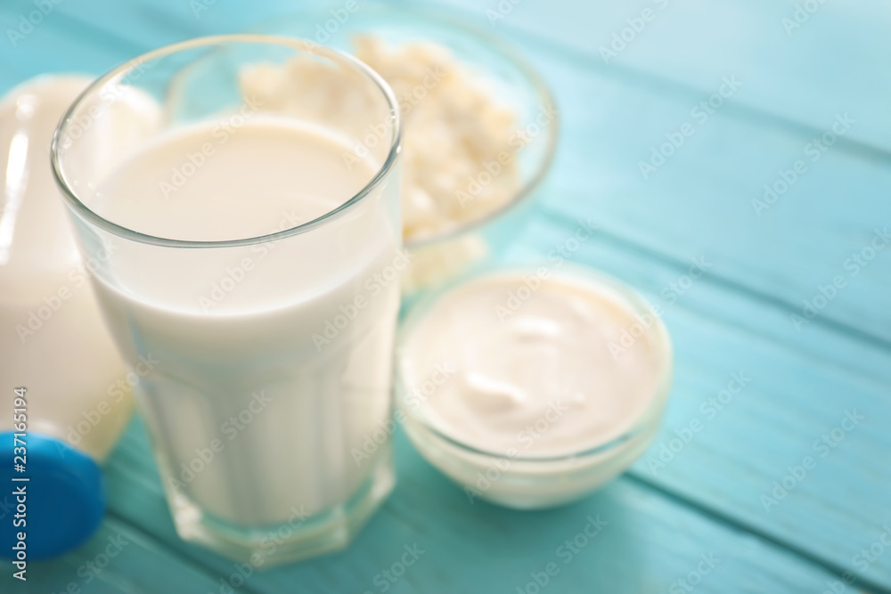Glass of milk on color wooden table Glass of milk on color wooden table