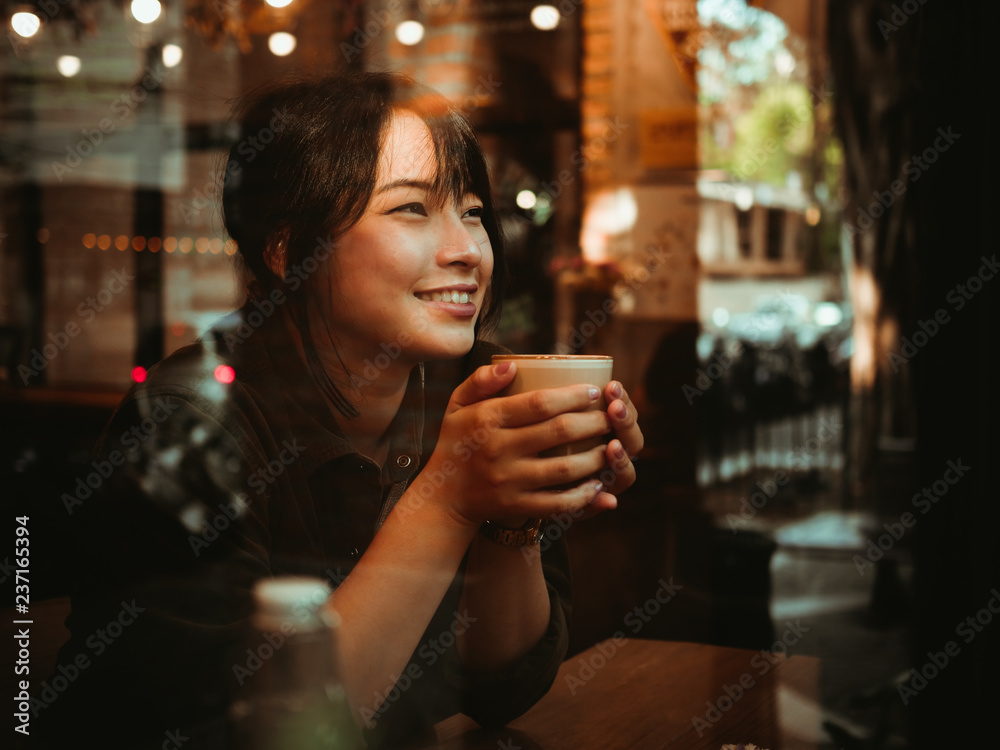 Asian woman drinking coffee in  coffee shop cafe