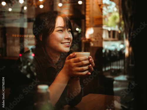 Asian woman drinking coffee in  coffee shop cafe