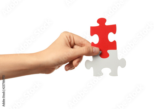 Woman with pieces of color puzzle on white background